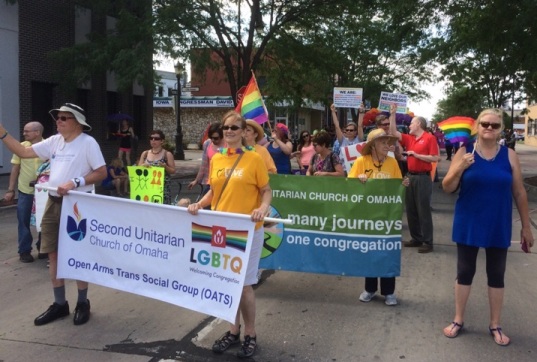 Church members holding banner as they march in Heartland Pride Parade