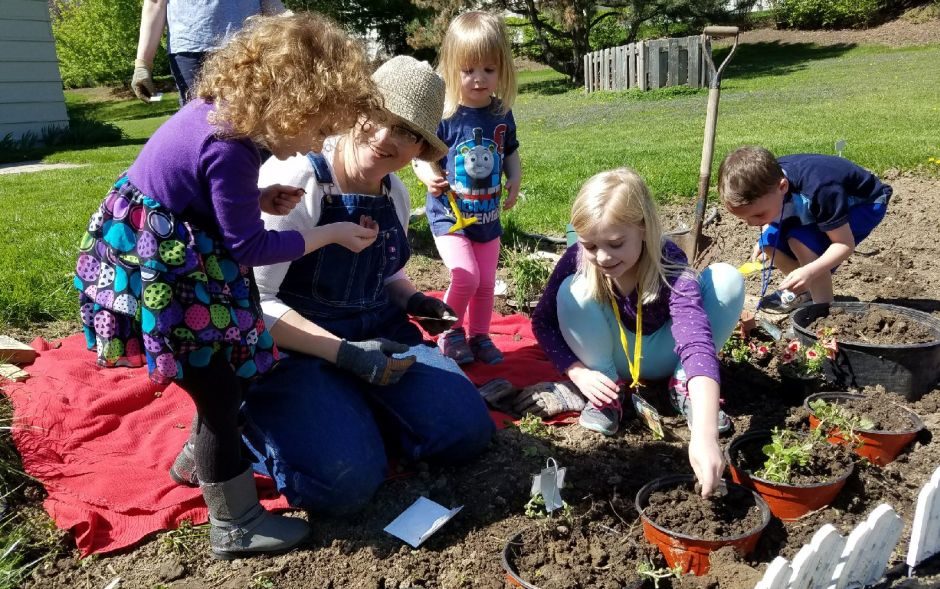 Children planting seeds in the Community Garden