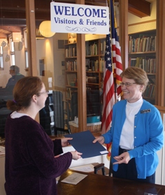 A guest is greeted at the Welcome Desk