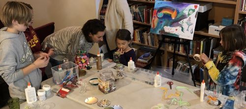 Children and parents decorating chalices.