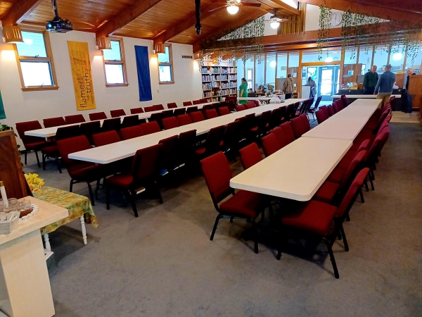 Three columns of tables set up in the 2U sanctuary, looking toward the coffee area.